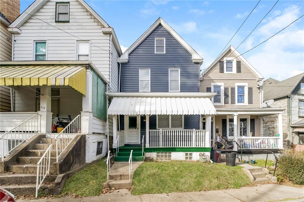 a front view of a house with a yard table and chairs