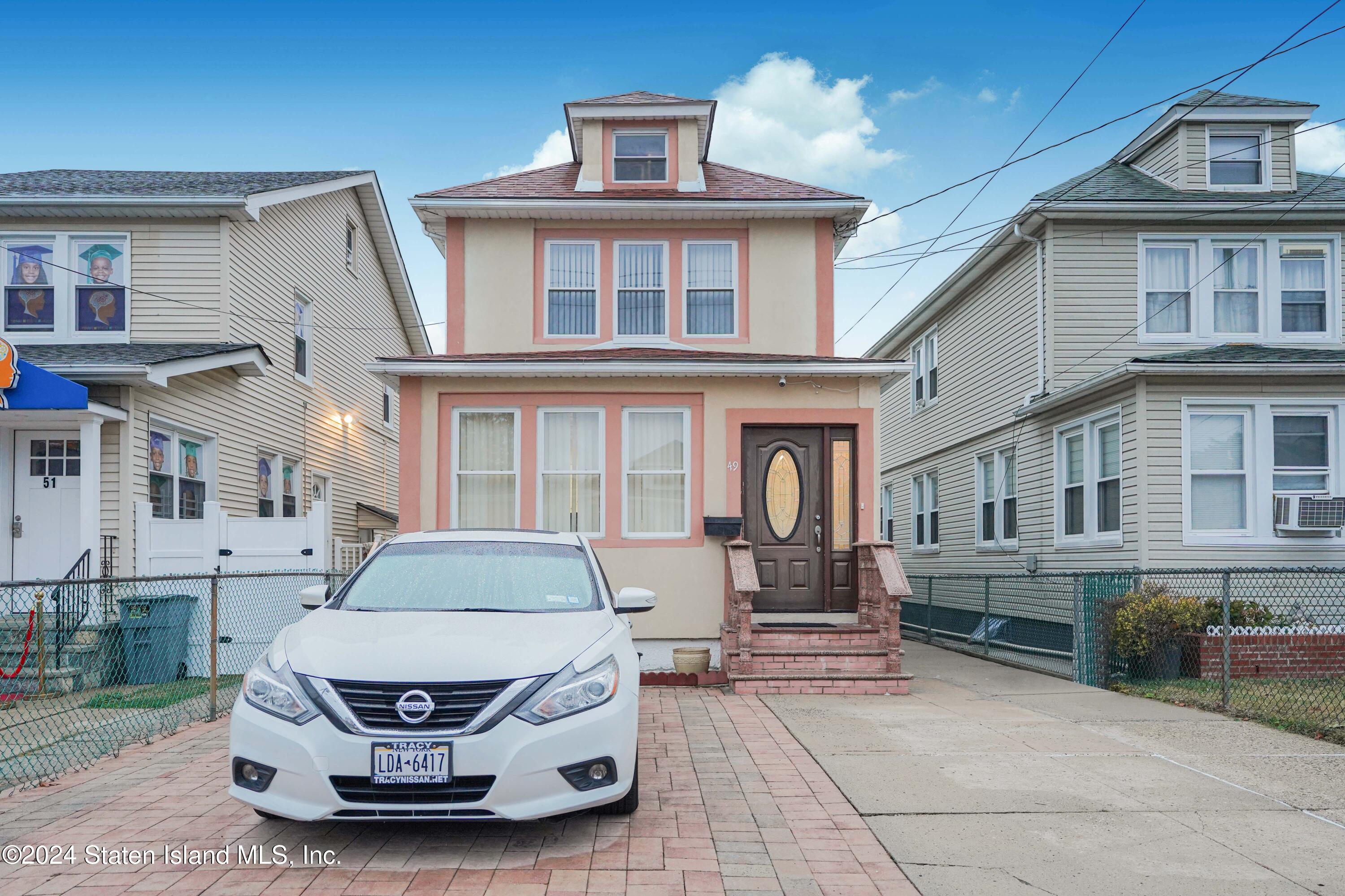 a car parked in front of a brick house