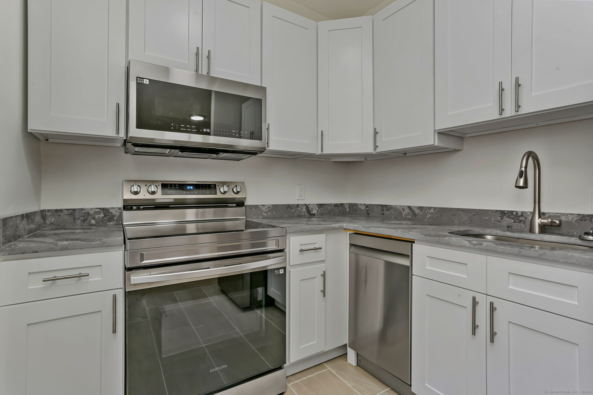 a kitchen with appliances a sink and cabinets