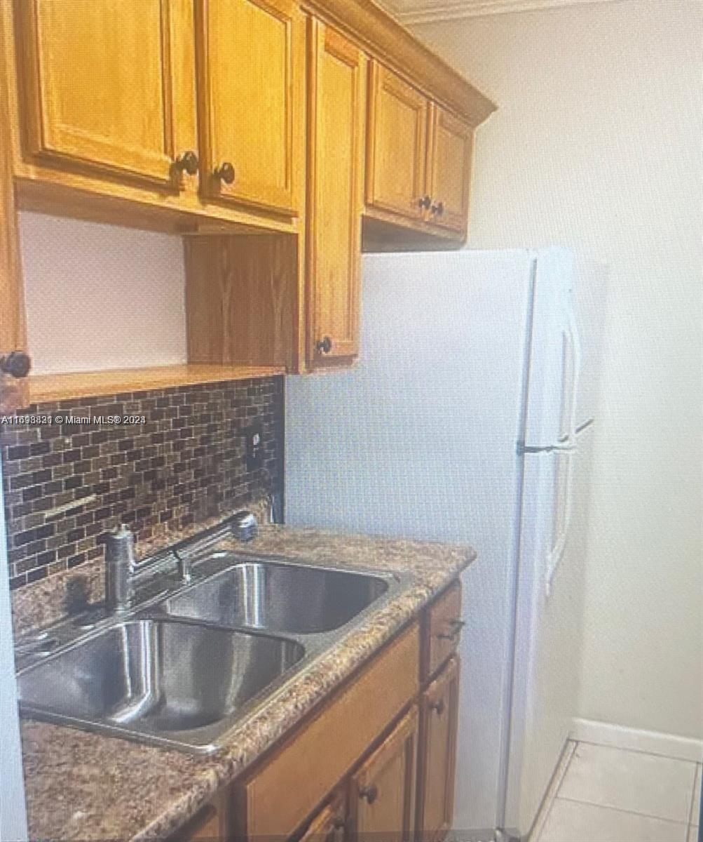 a close view of a sink and a refrigerator