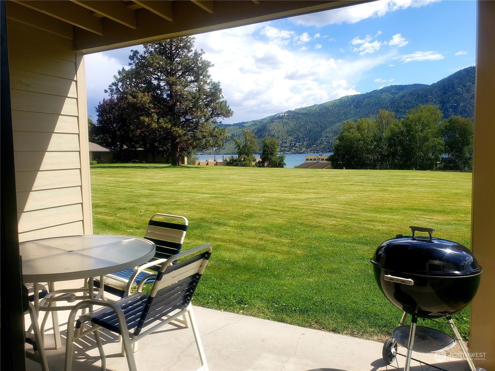 a view of a backyard with sitting area