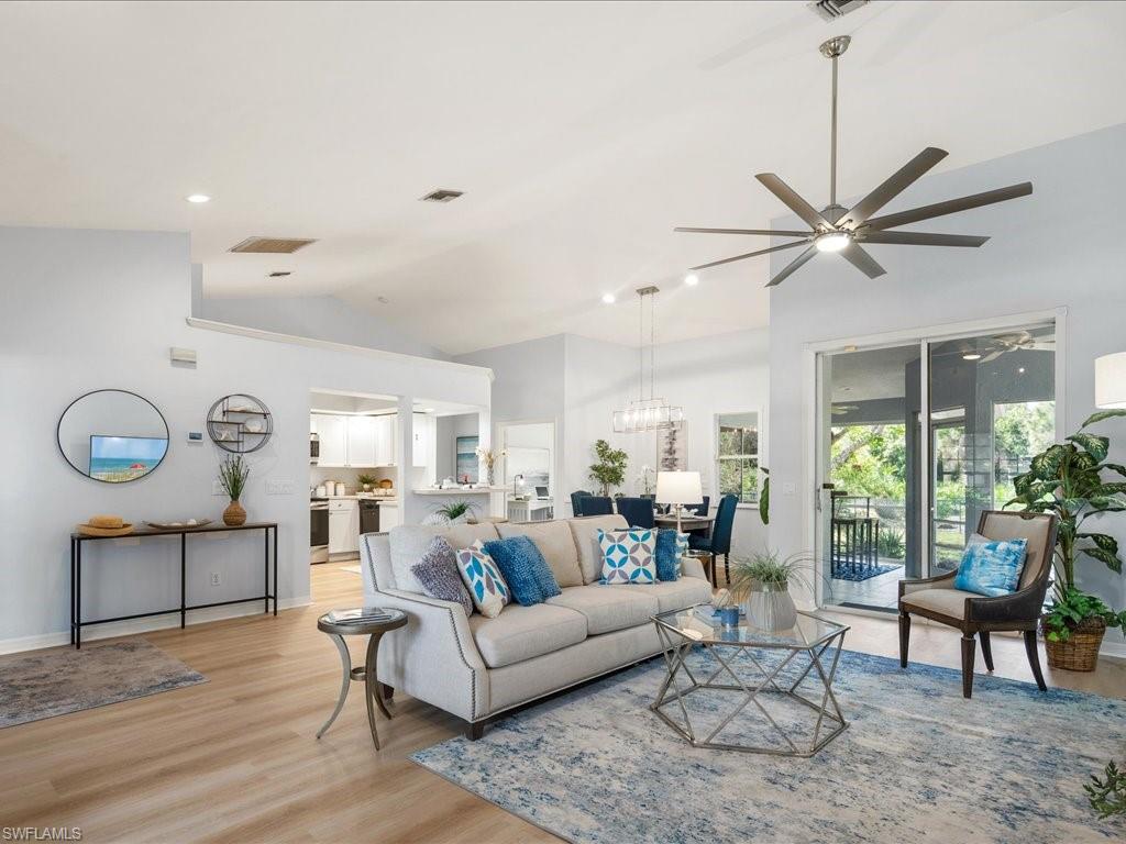 a living room with furniture a clock and a large window