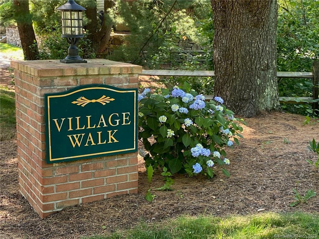 a sign that is sitting in front of flowers