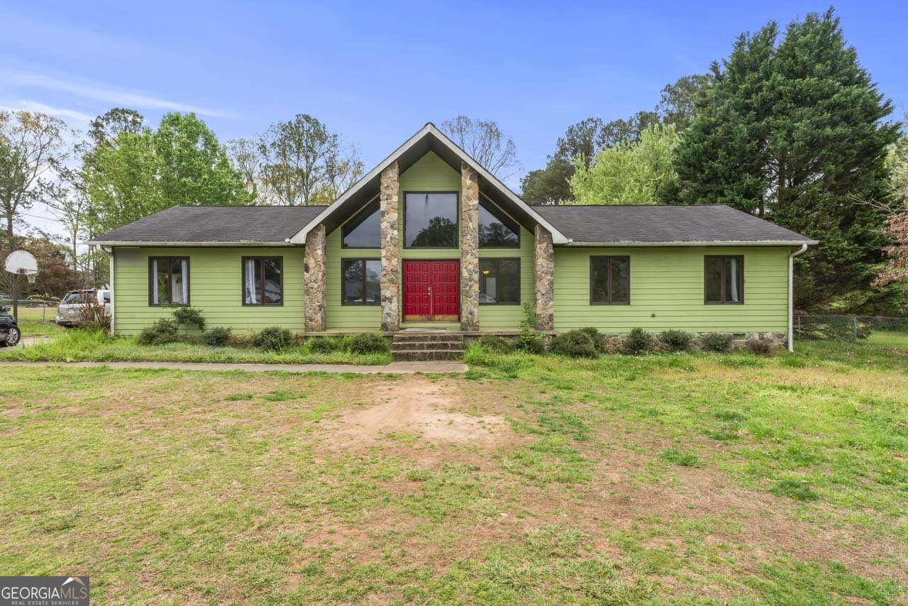 a front view of house with yard and green space