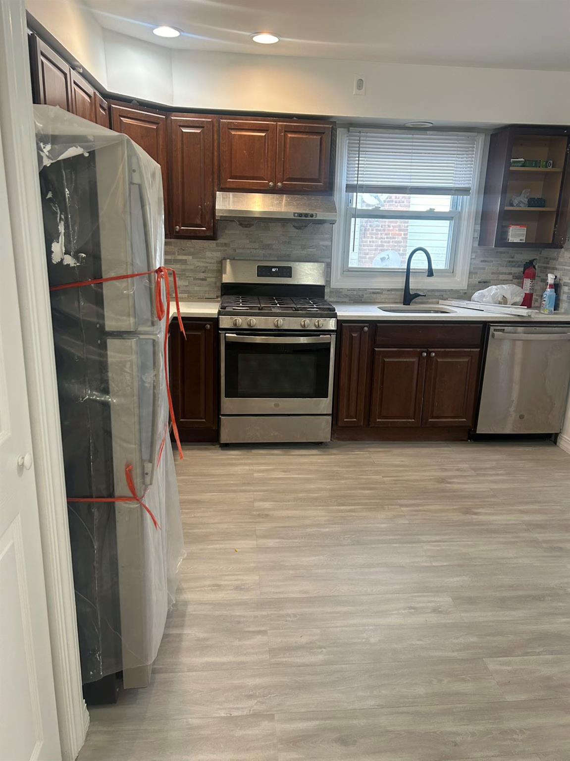 a kitchen with stainless steel appliances a refrigerator and a sink