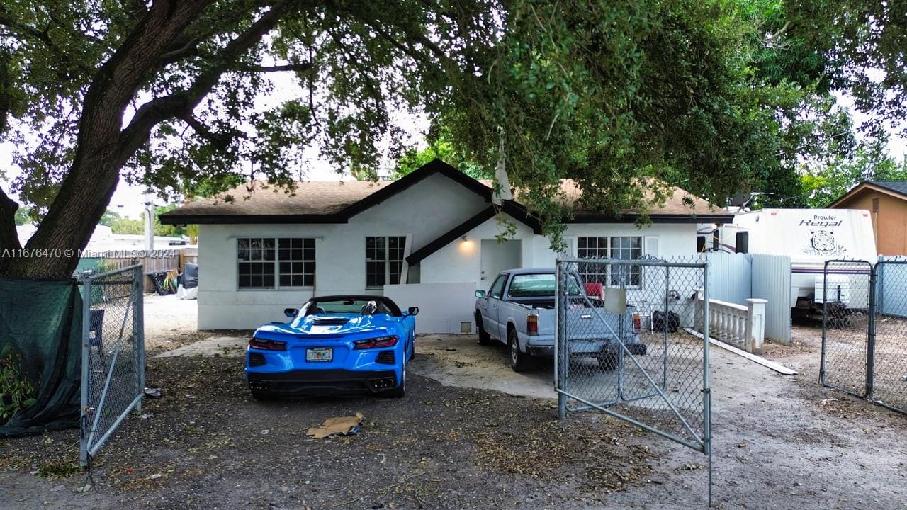 a car parked in front of house with a yard