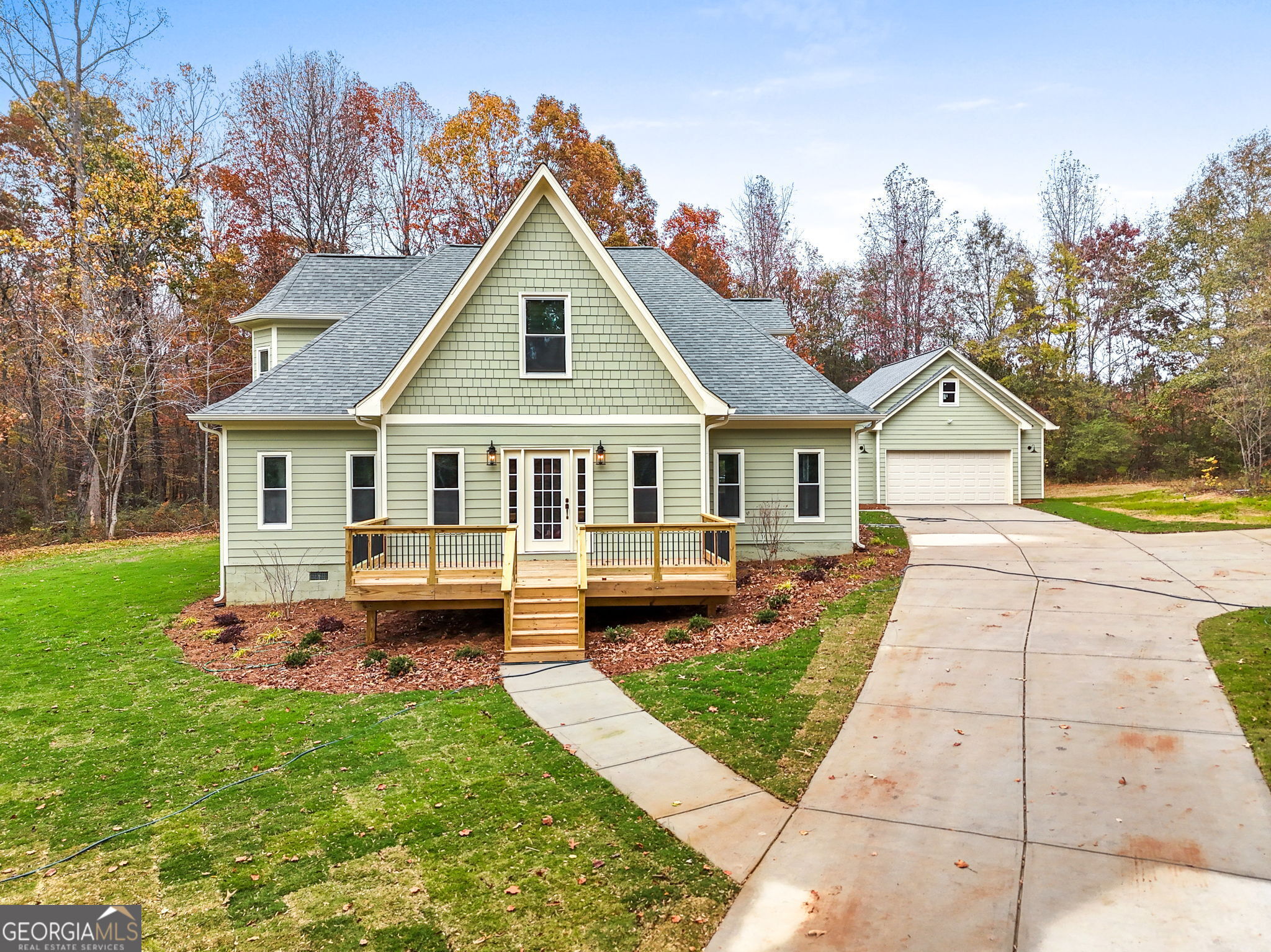 a front view of house with yard and green space