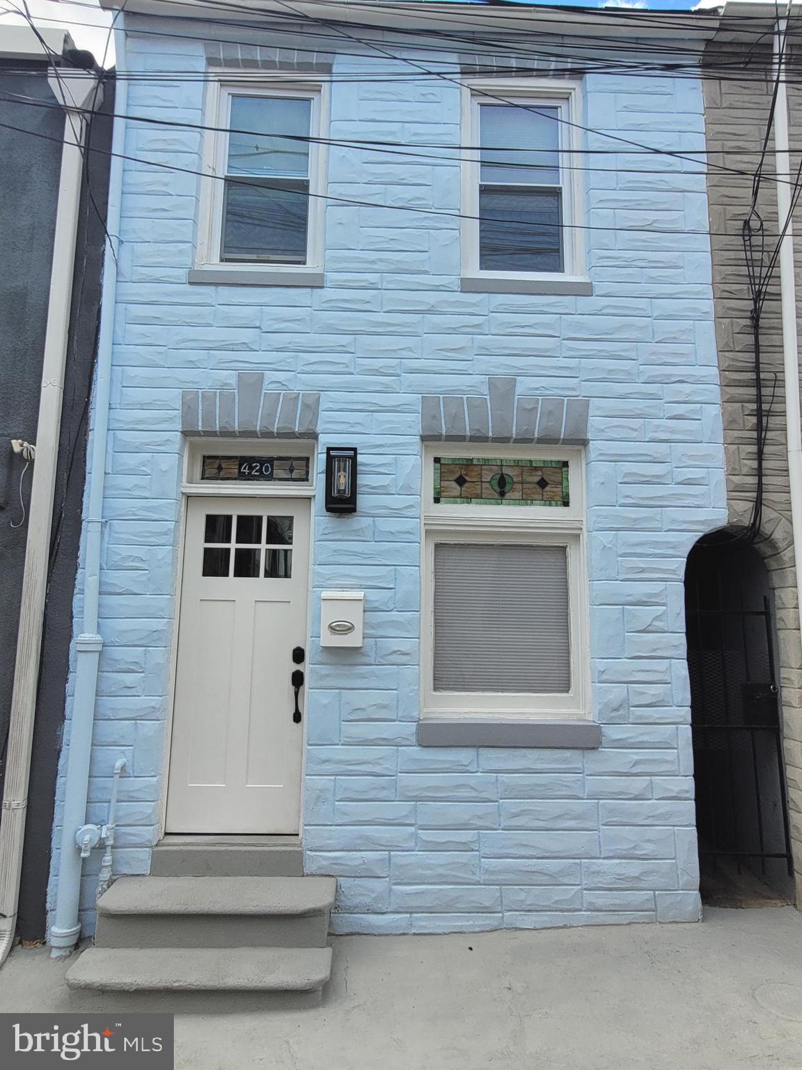 a front view of a house with stairs