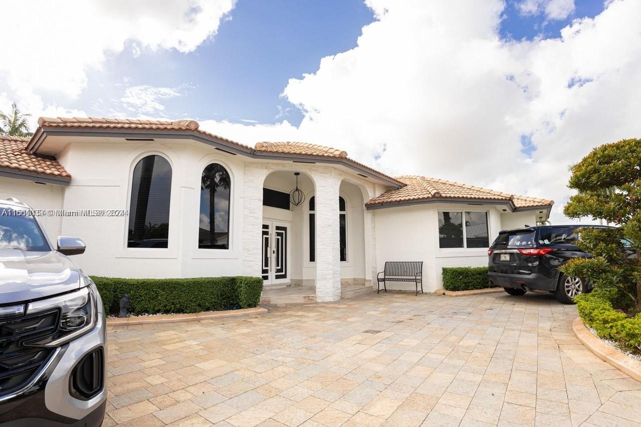 a view of a white house with a outdoor space