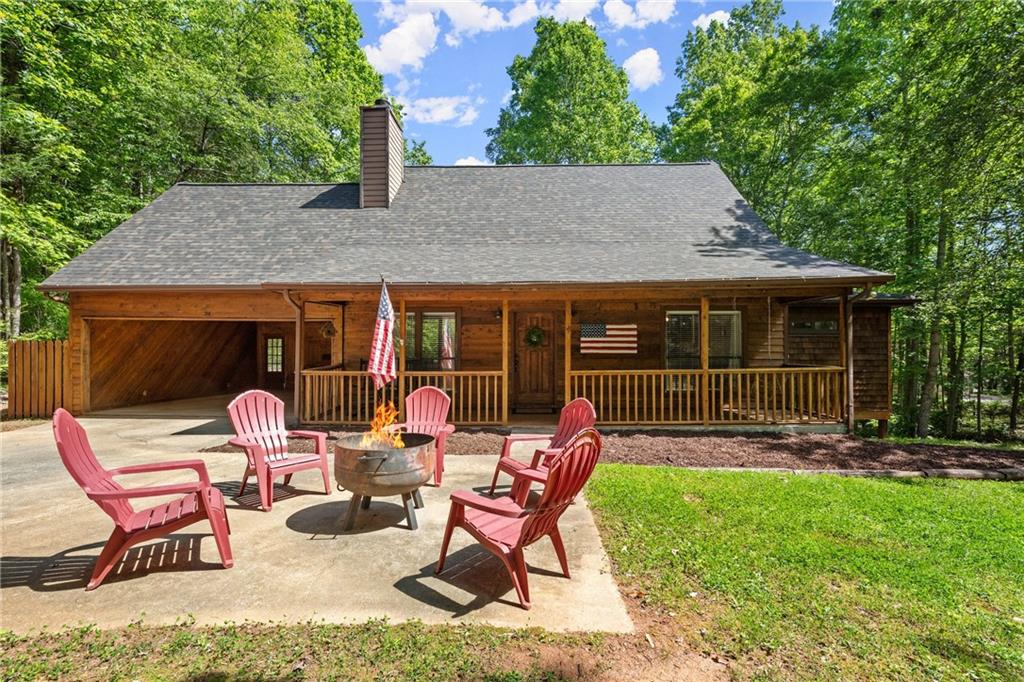 a view of a house with backyard sitting area and porch