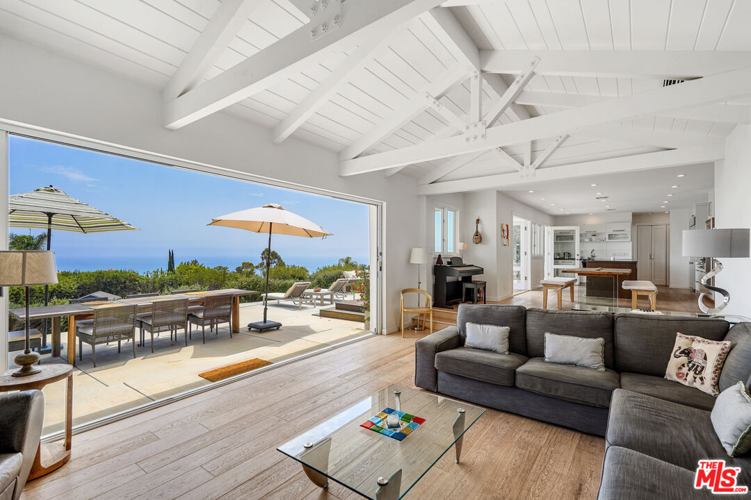 a living room with furniture and a floor to ceiling window