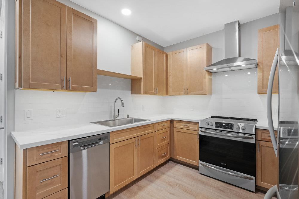 a kitchen with a sink stove and cabinets