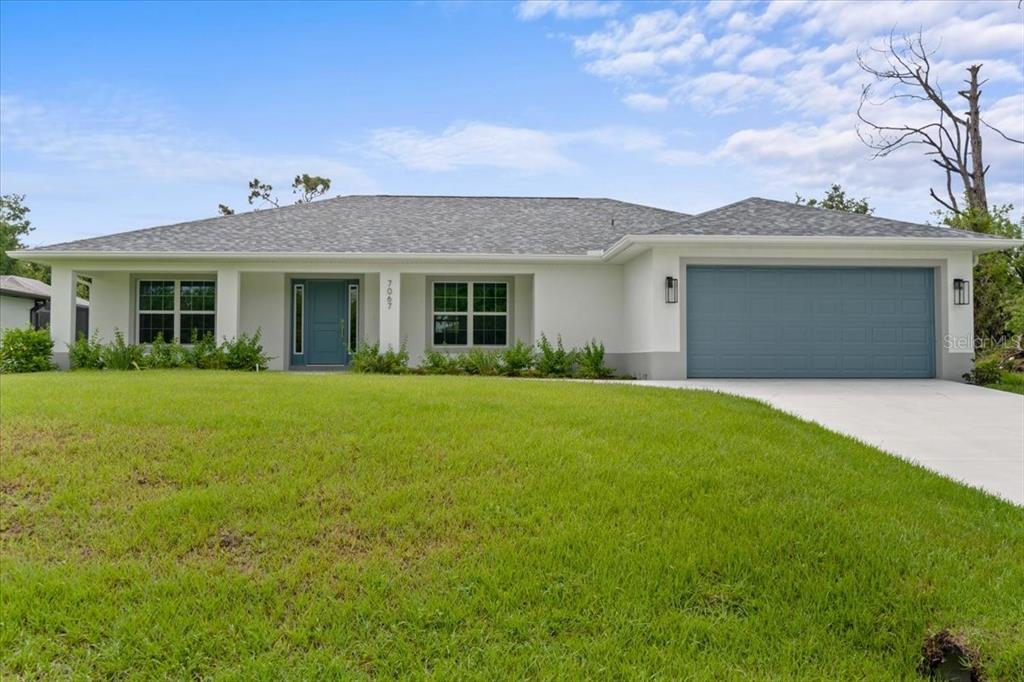 a front view of house with yard and green space