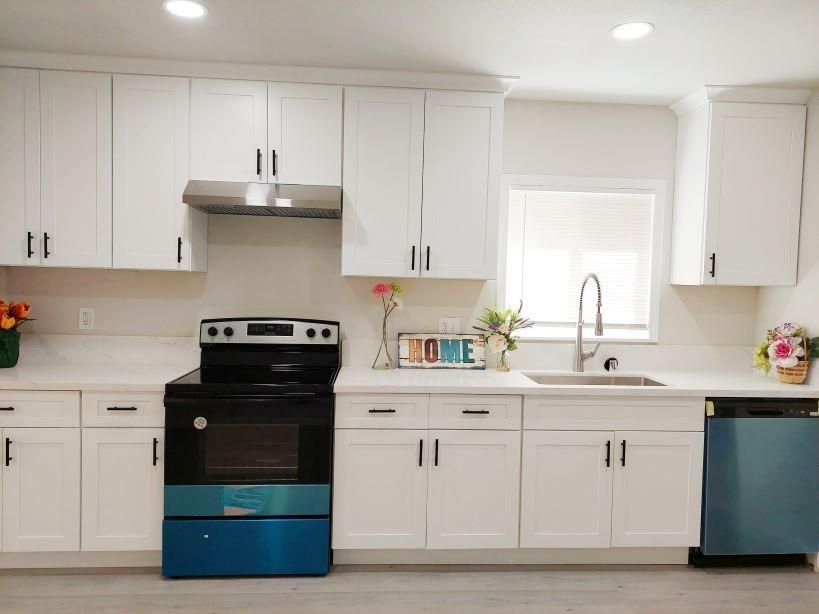 a kitchen with white cabinets and a stove