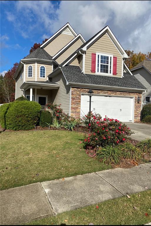 a front view of a house with a yard