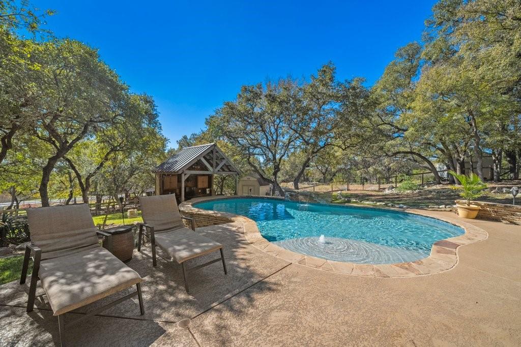 a view of backyard of house with green space