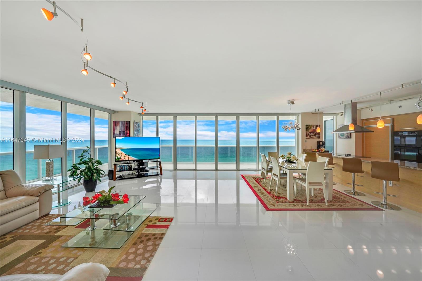 a living room with furniture and a floor to ceiling window