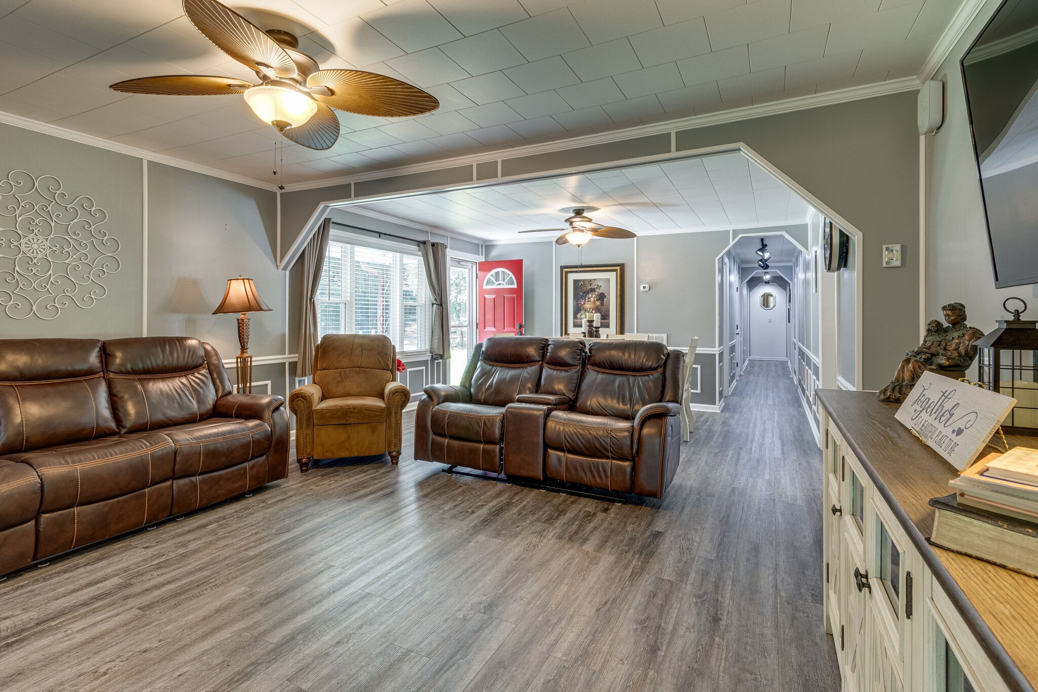 a living room with furniture wooden floor and a chandelier