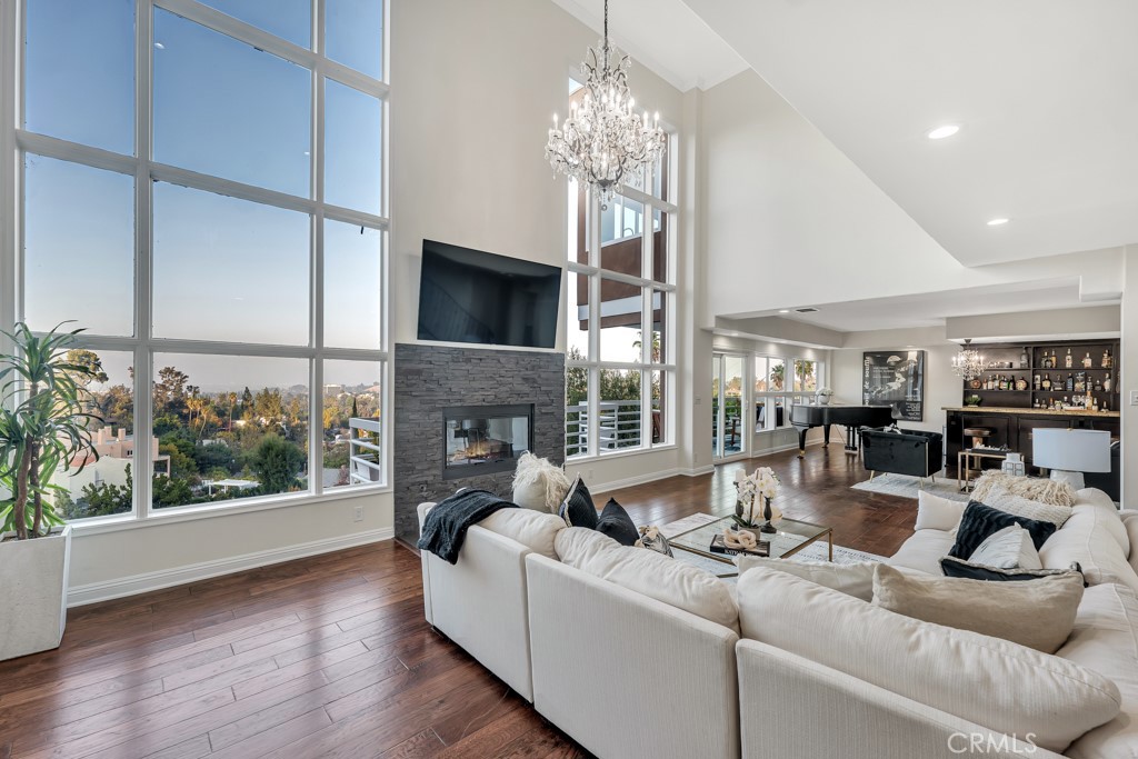 a living room with furniture a fireplace and a chandelier