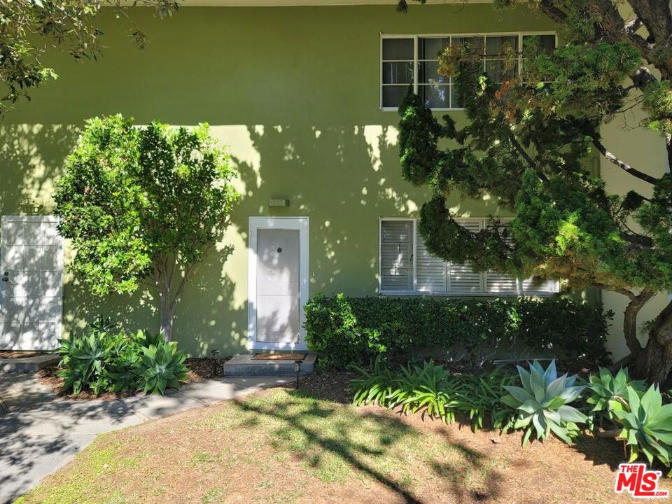 a view of a house with a tree in a yard