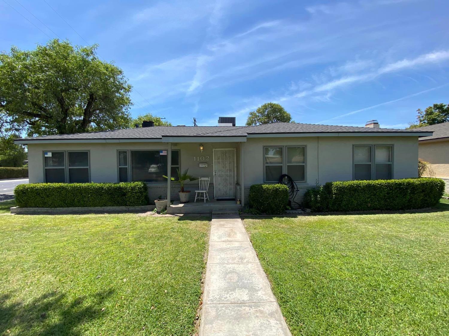 a front view of house with yard and green space