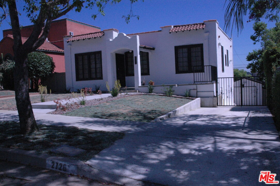 a view of a house with backyard space and balcony