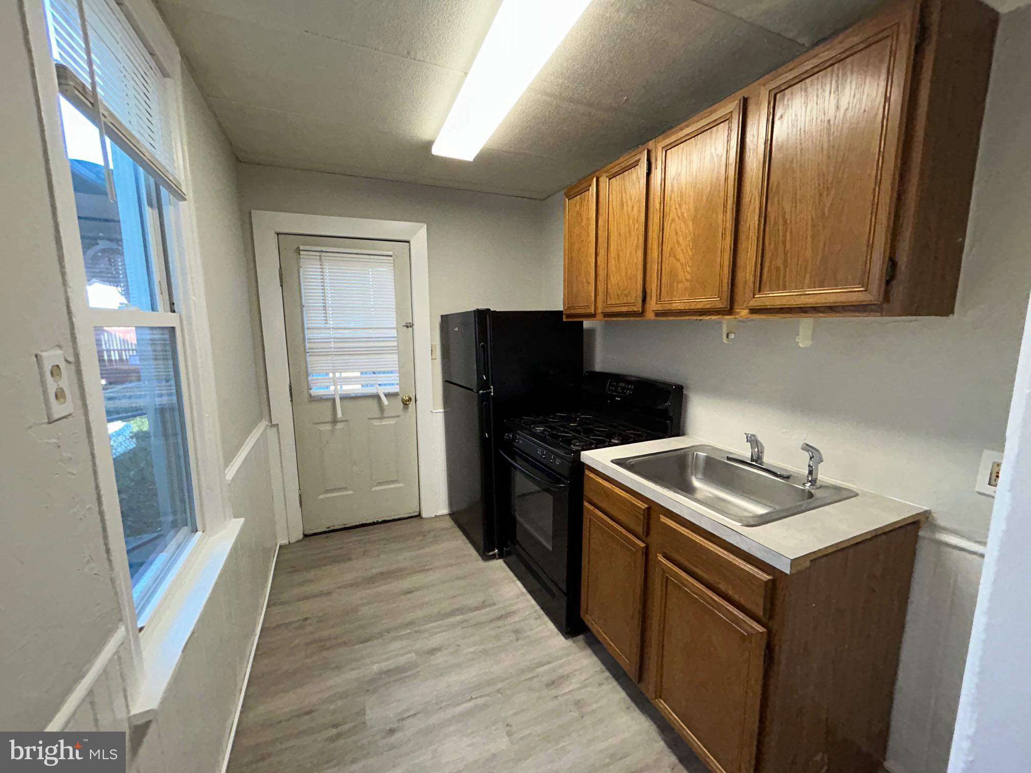 a kitchen with a sink stove and refrigerator