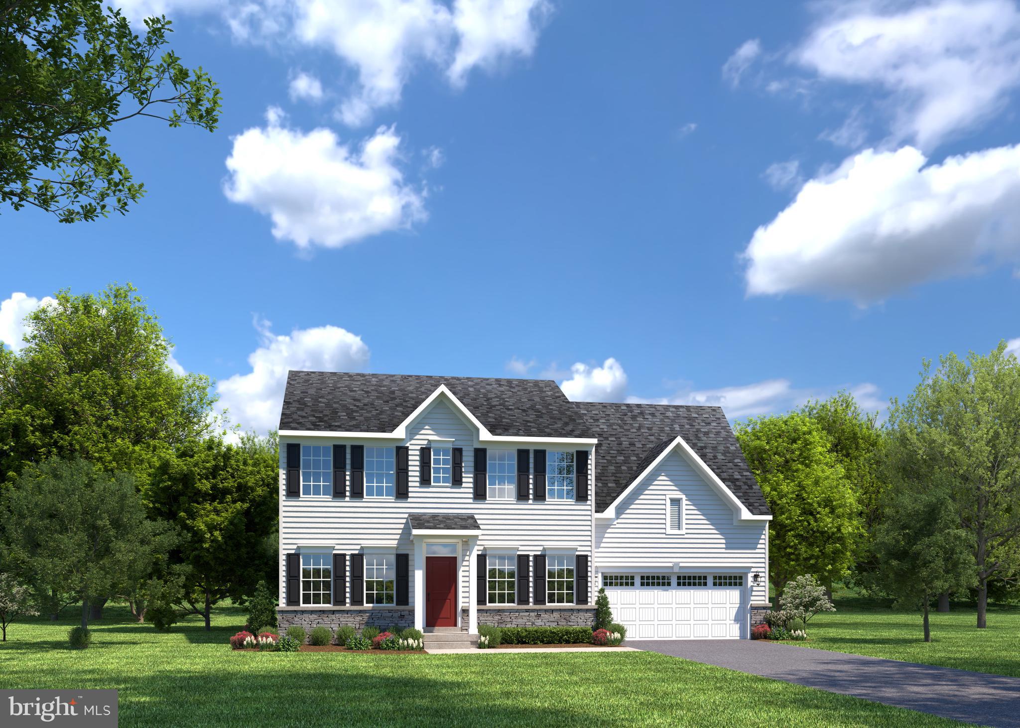 a front view of a house with a garden and trees