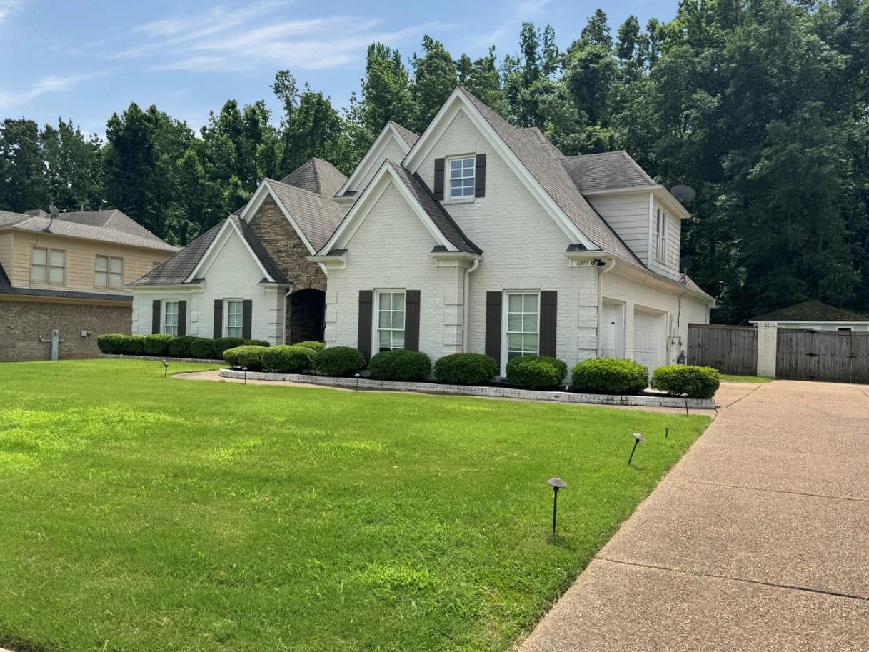 View of front of home featuring a front yard and a garage