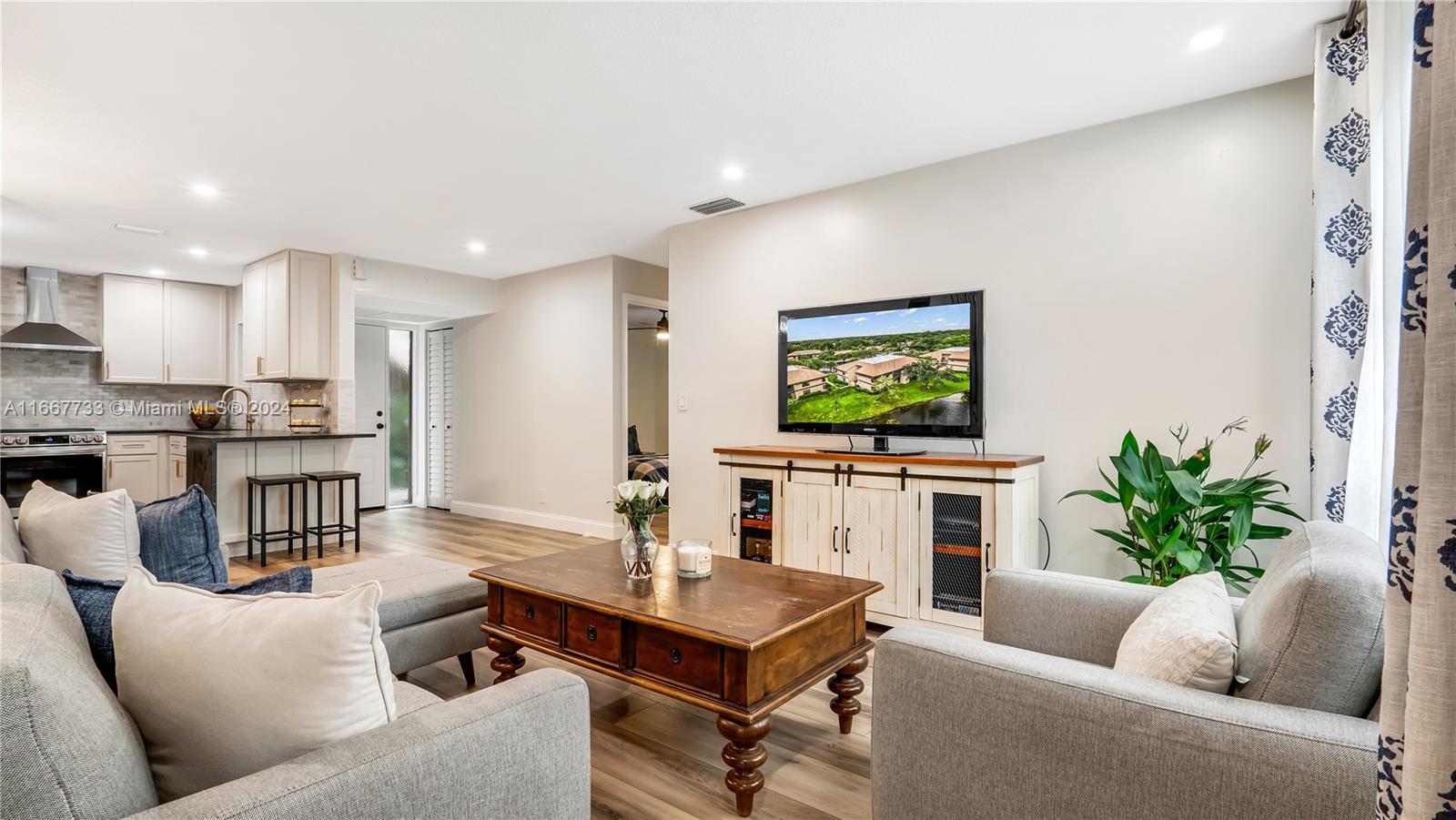 a living room with furniture and a flat screen tv