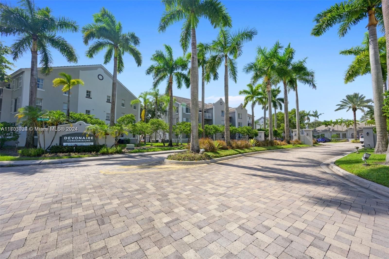 a row of palm trees in front of house