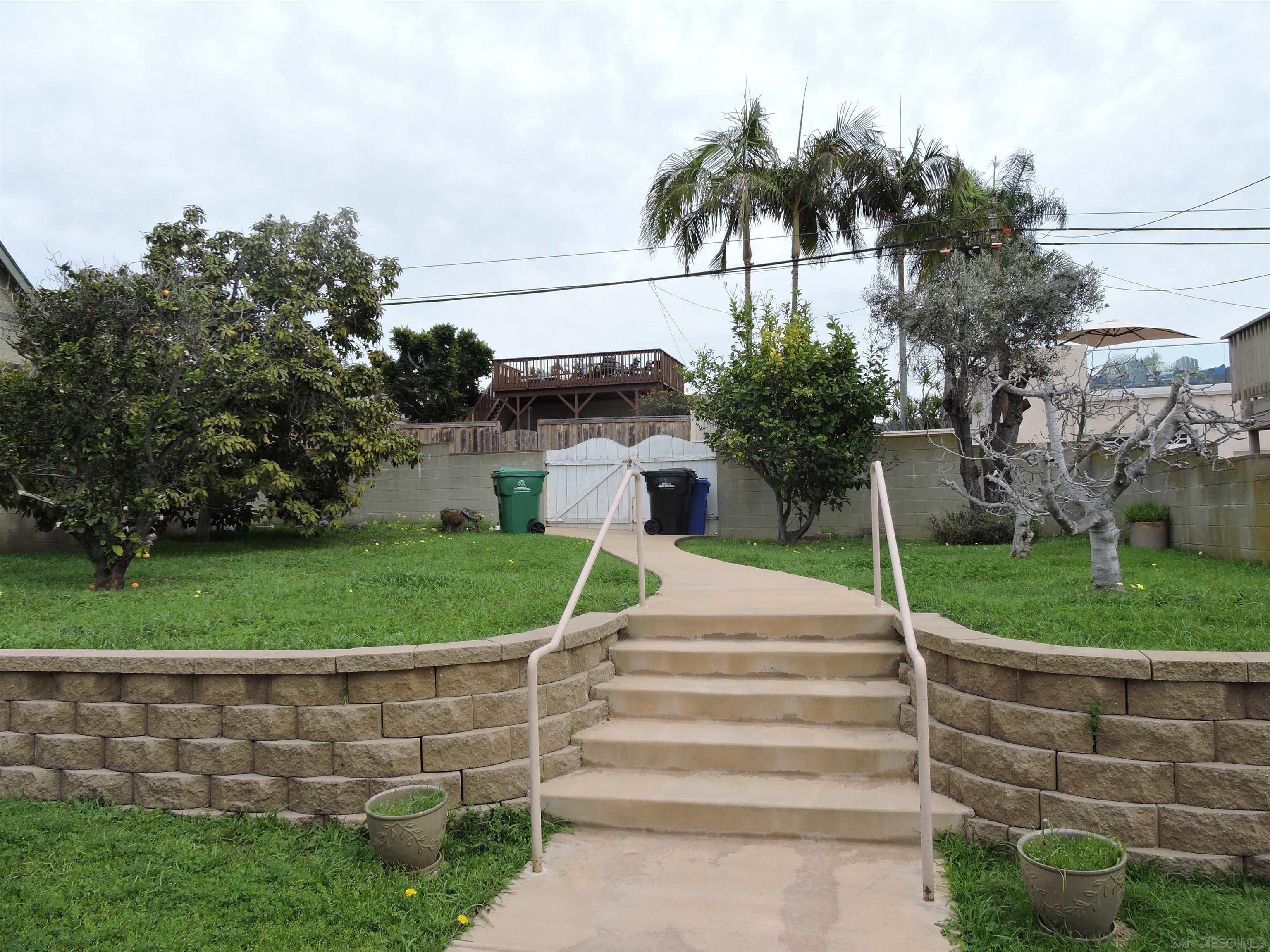 a front view of a house with a yard and entertaining space