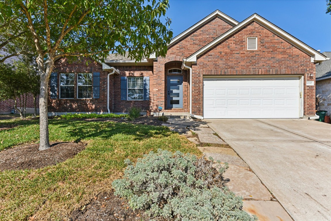 a front view of a house with a yard and garage