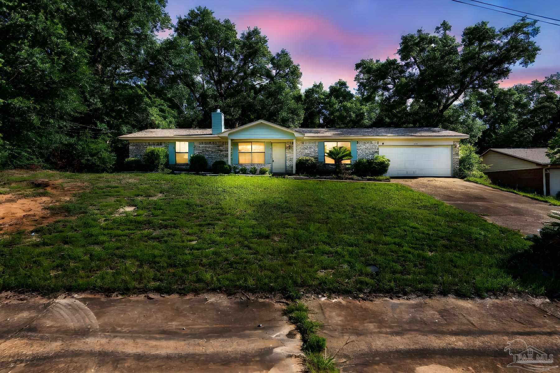 a front view of a house with a garden