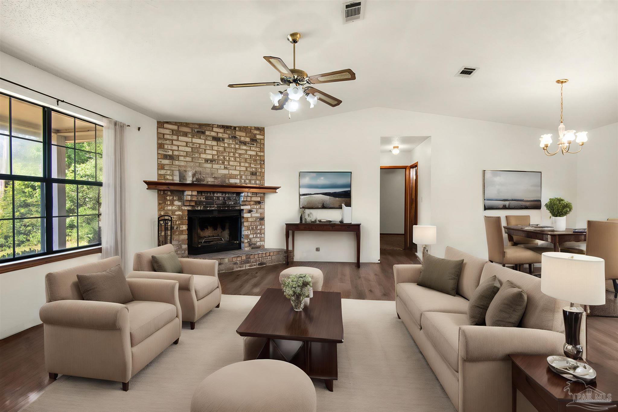 a living room with furniture a fireplace and a large window