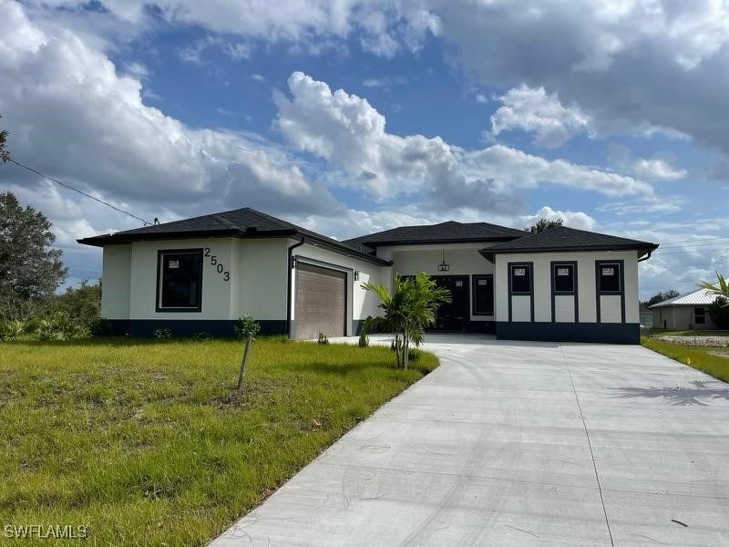 a front view of house with yard and green space