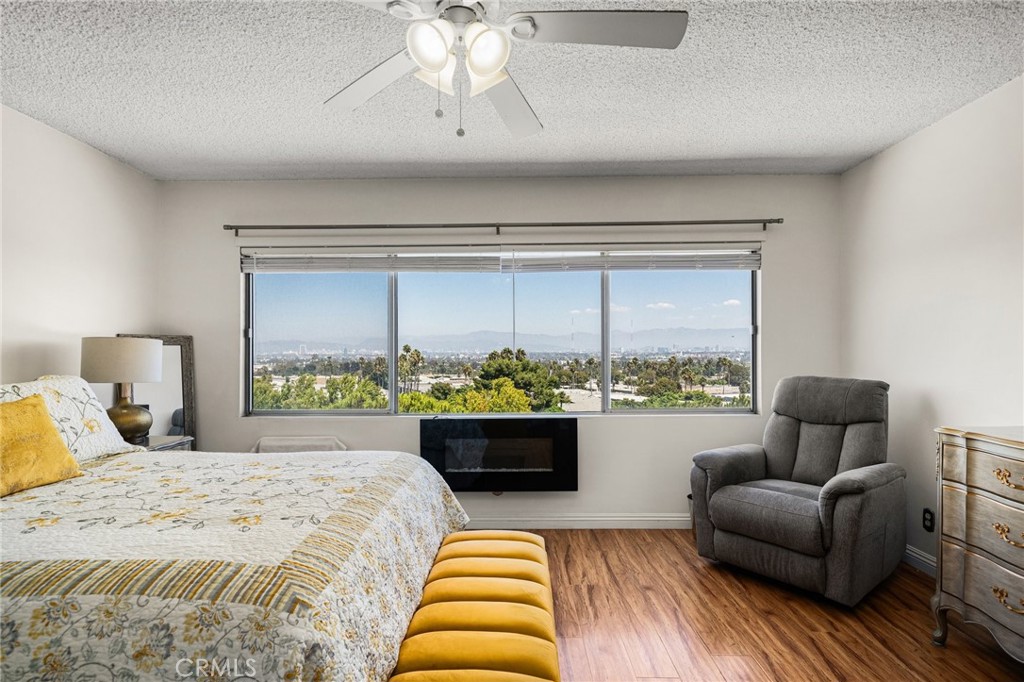 a bedroom with furniture and a large window