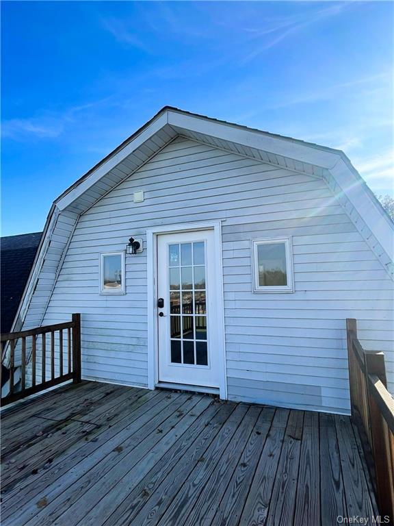 a view of a house with wooden deck