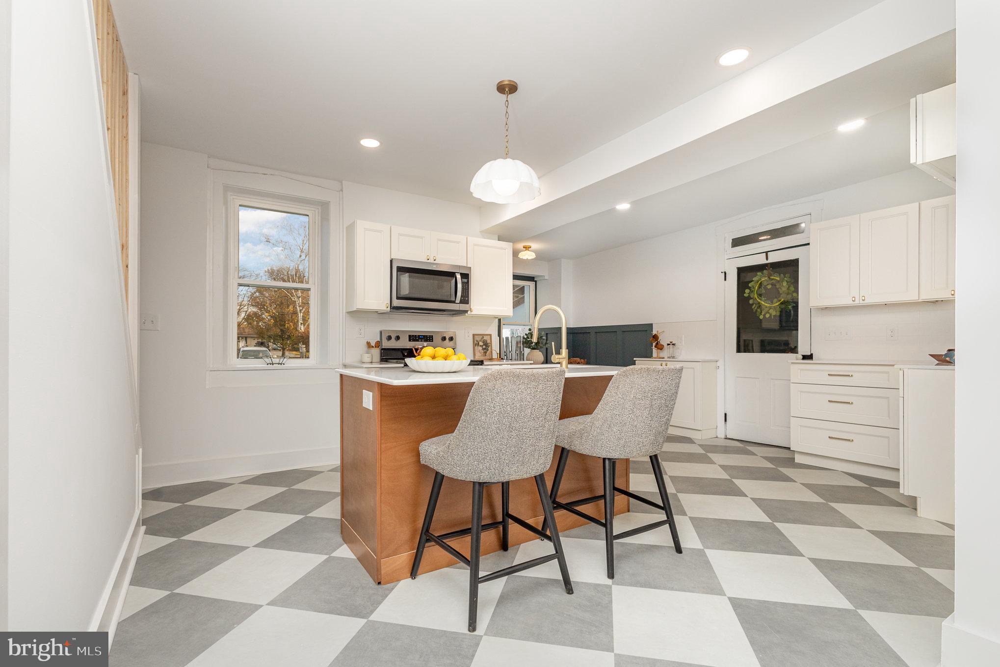 a living room with furniture a dining table and kitchen view