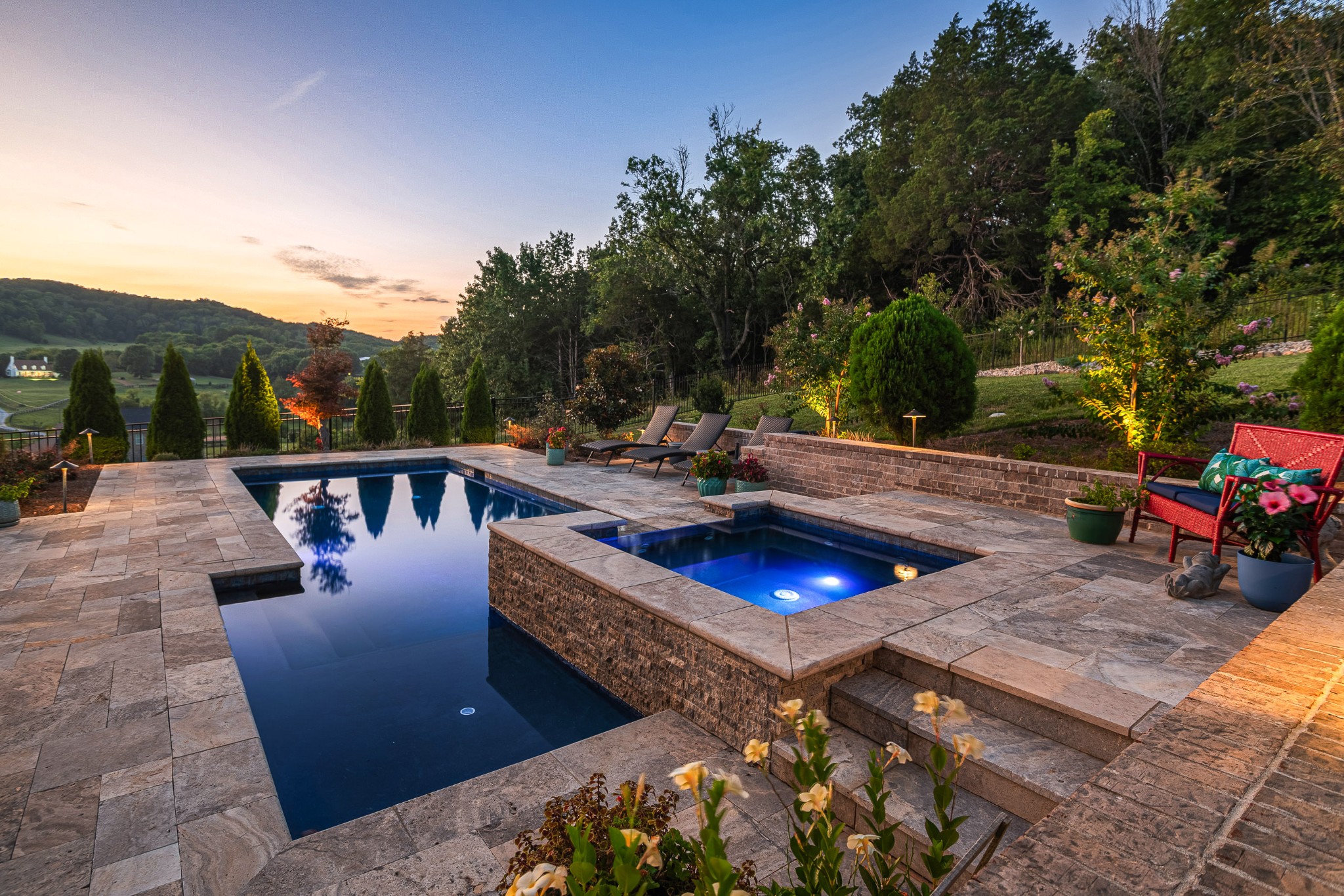 a view of a swimming pool with couches and wooden floor