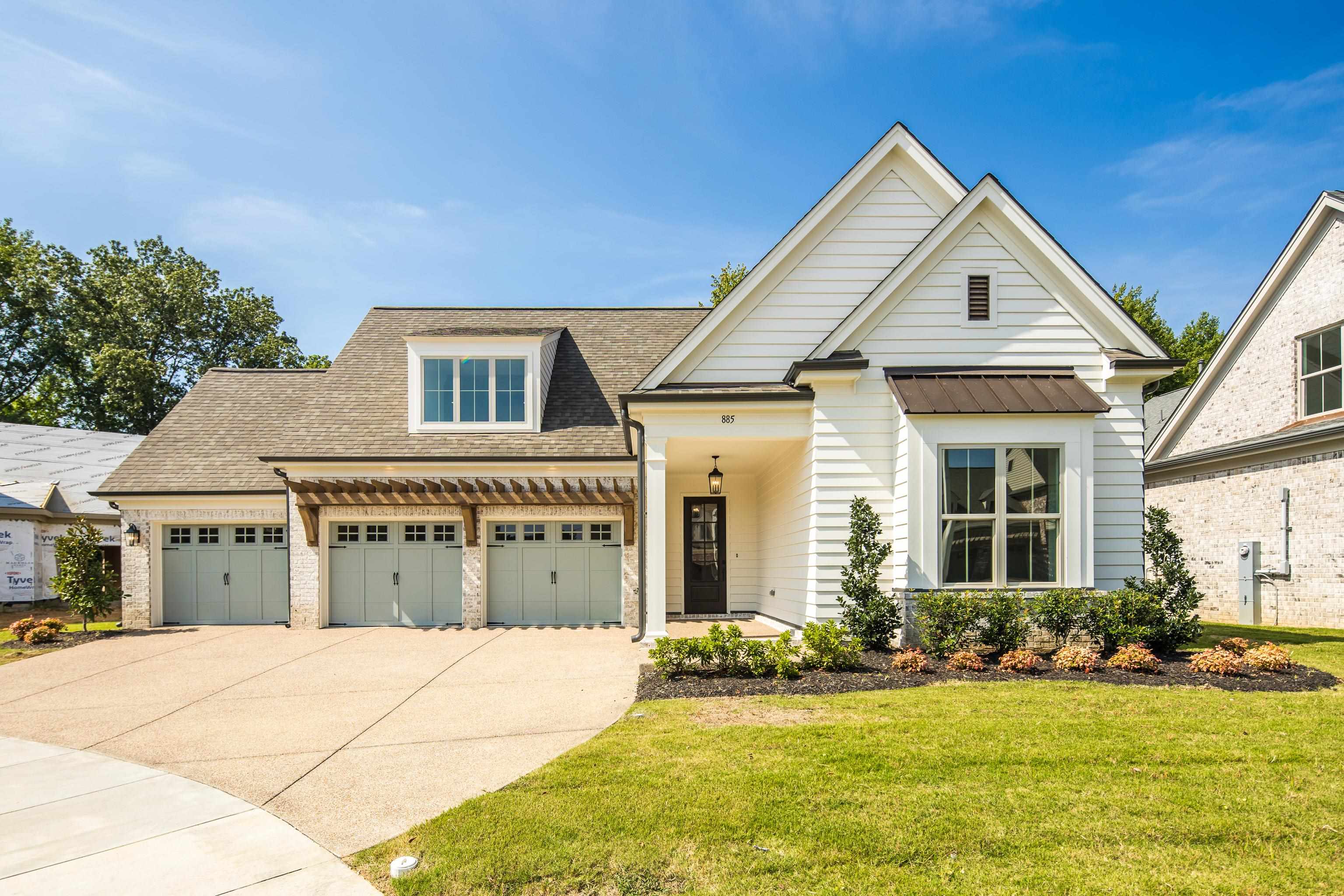 View of front of house with a front yard and a garage