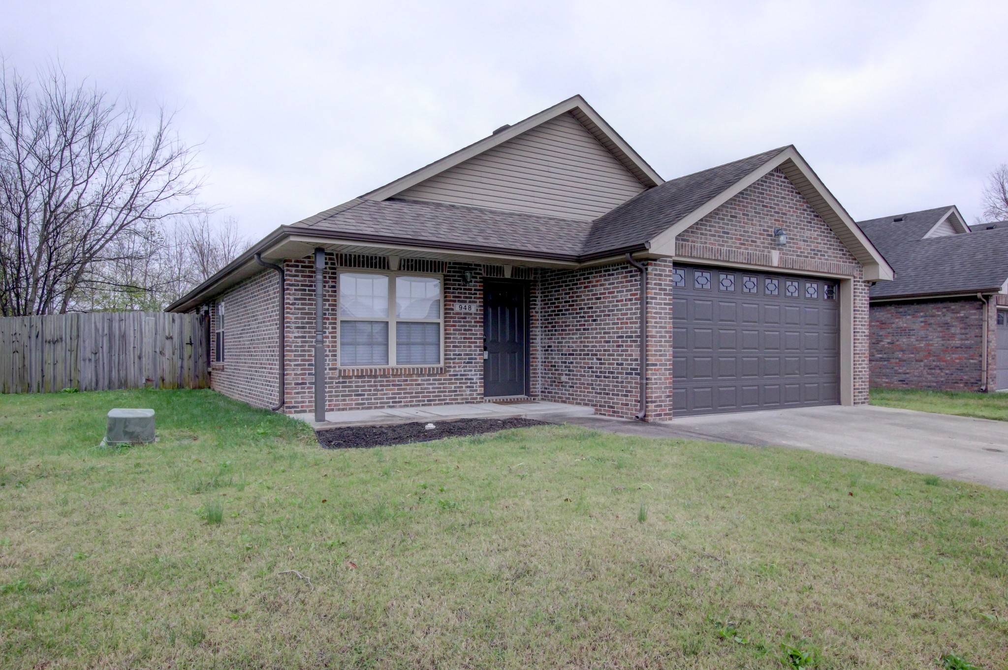 a front view of a house with a garden and garage