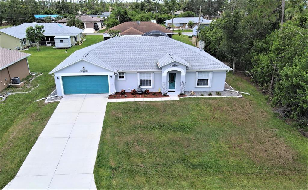 a aerial view of house with yard