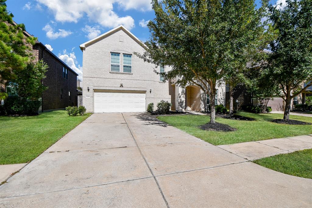 Gently grand and very impressive, this single family, 2 story brick treasure is located at 27314 Lynwood Park Drive, Katy, TX, in the Canyon Lakes at Cardiff Ranch community. Pictured here are the dual attached garages, among impeccably maintained landscaping.