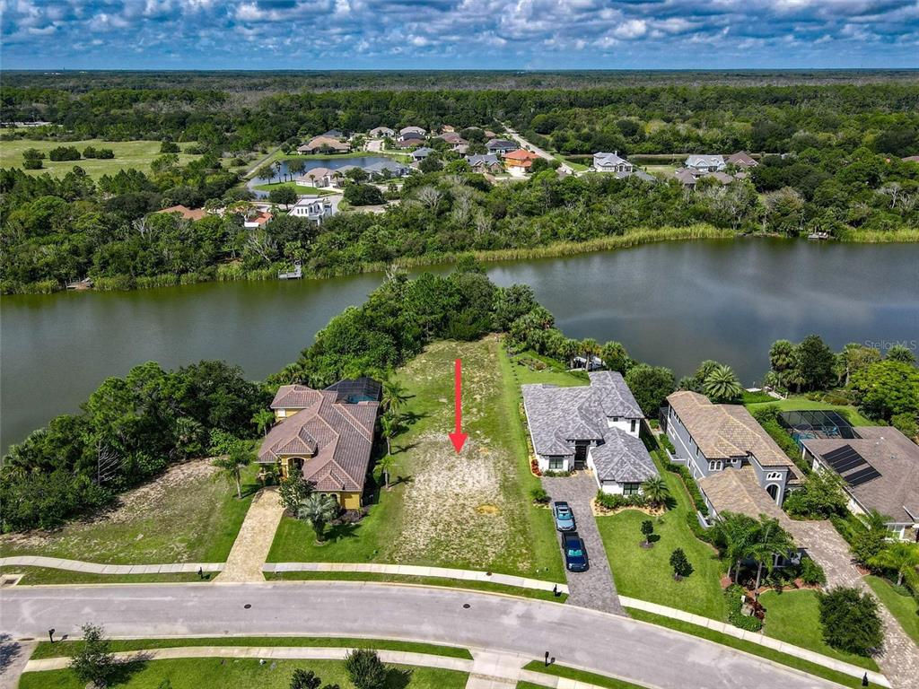 an aerial view of a house with a lake view