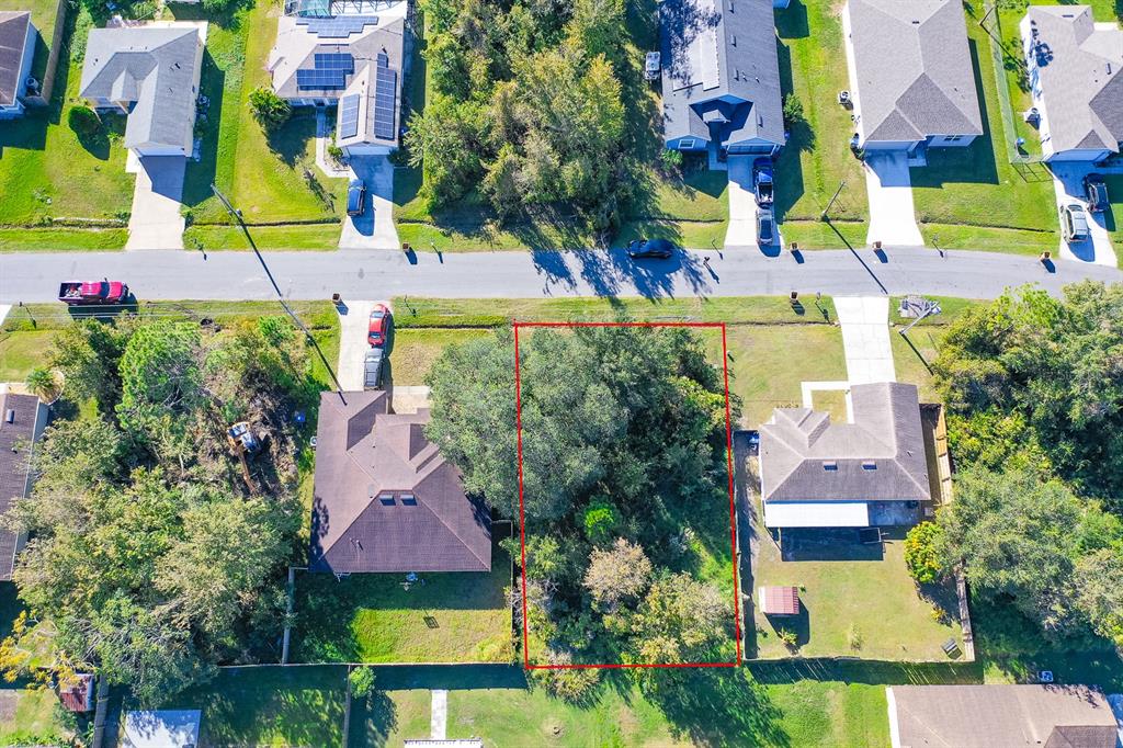 an aerial view of multiple houses with yard and swimming pool