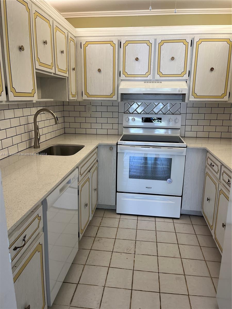 a kitchen with stainless steel appliances a sink stove and cabinets