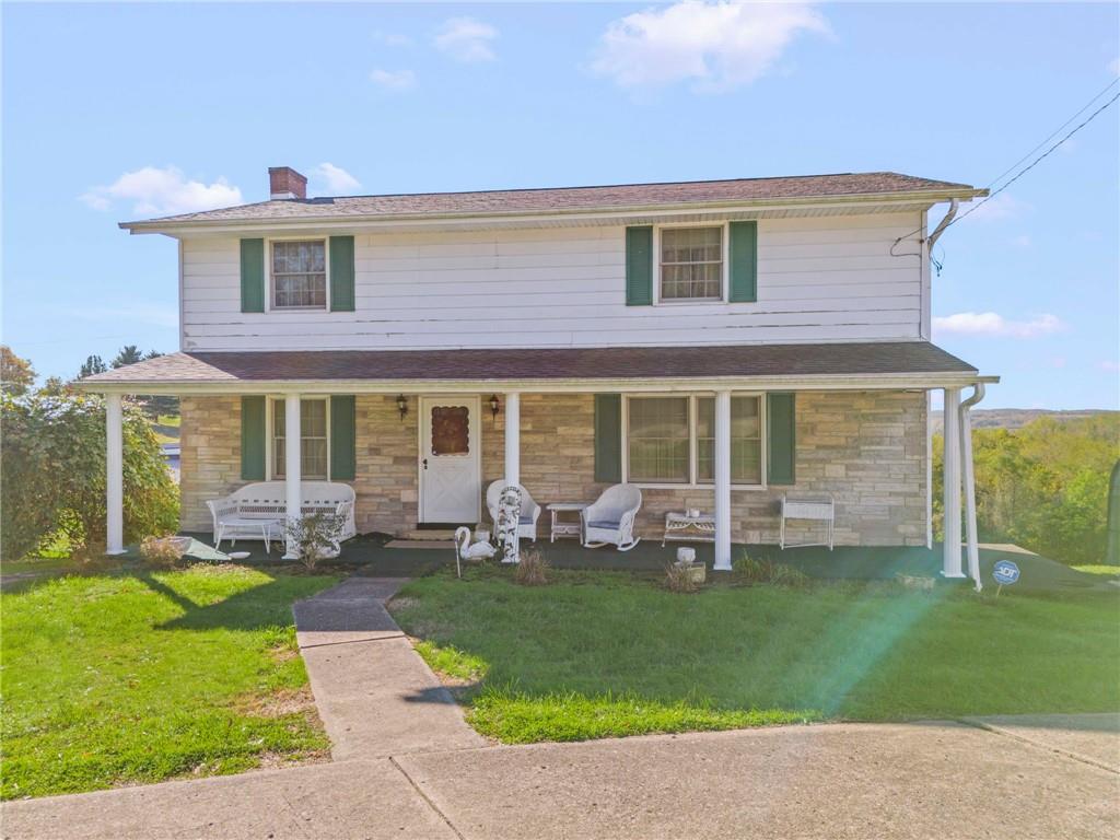 a front view of house with a garden and patio