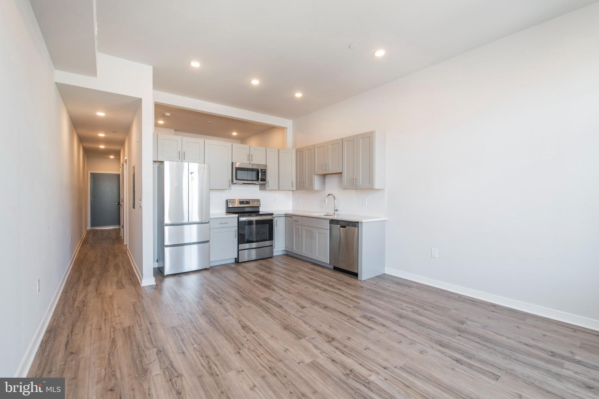 a kitchen with stainless steel appliances a sink and a refrigerator