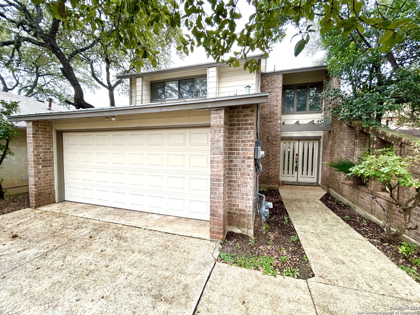 a front view of a house with a garage